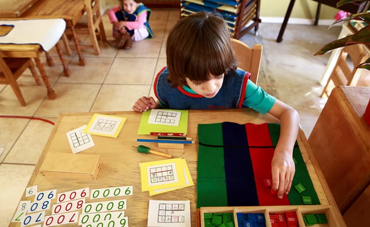 A child is sorting colors inside the children’s house at Mountain West Montessori.